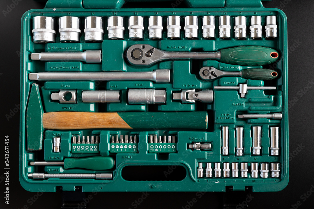 Tools in the set. Wrenches, hammer, pliers and other tools in the set. Black isolated background. Tools in the set. Wrenches, hammer, pliers and other tools in the set. Black isolated background.