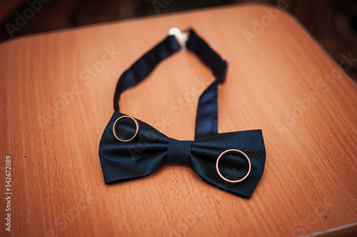 Pair of gold wedding rings on the blue bowtie