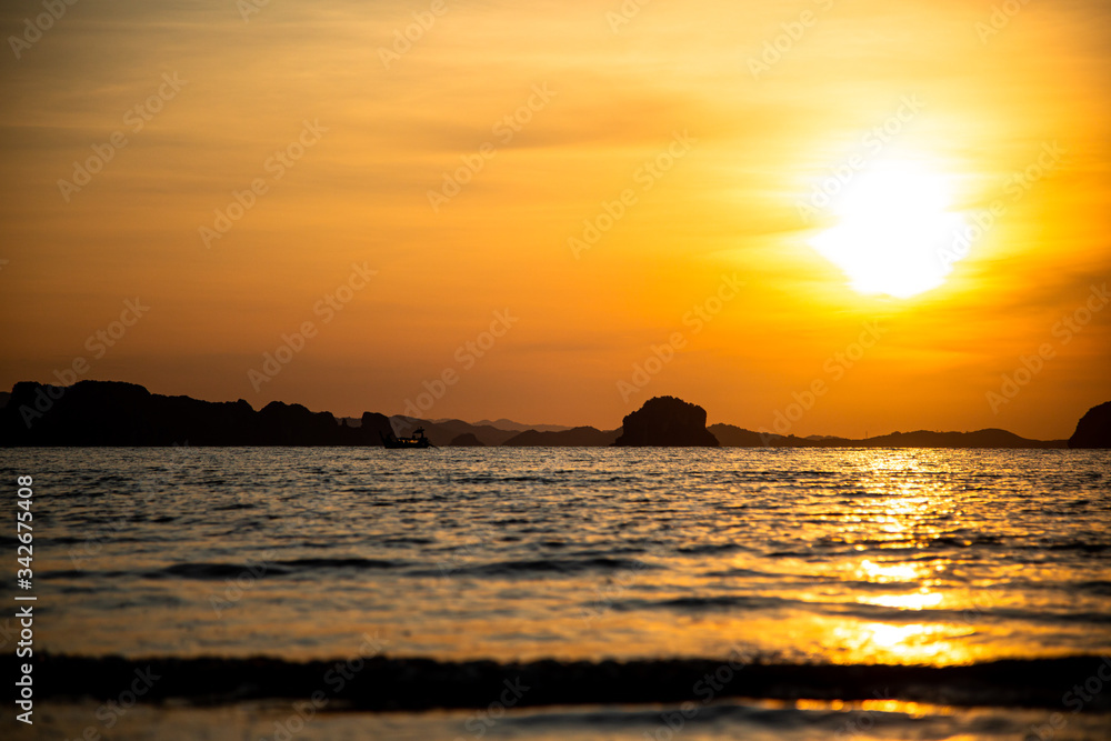 Beautiful sunset on the beach with islands