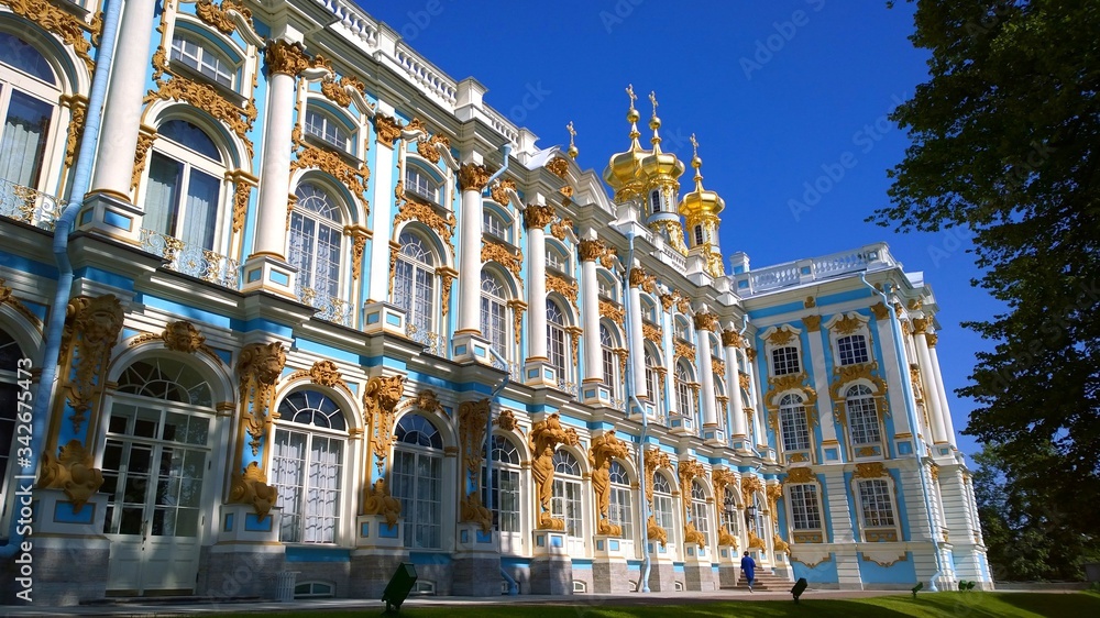 Facade of the Catherine Palace and golden domes of the Chapel - Imperial Court Church, located in Pushkin, a suburb of St. Petersburg, Russia. Luxurious real estate. Russian royal tourist attractions.