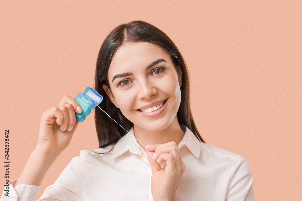 Beautiful young woman with dental floss on color background Beautiful young woman with dental floss on color background