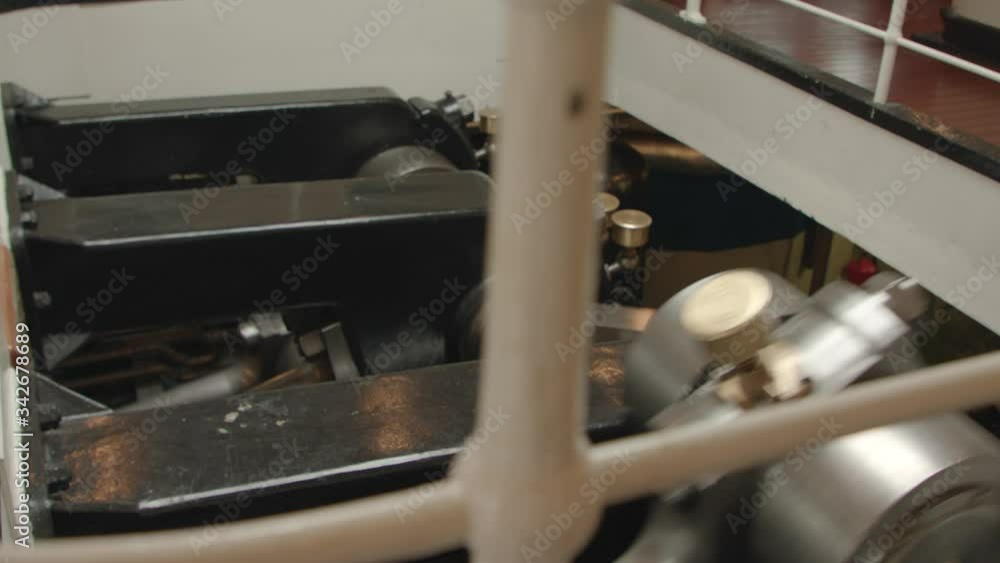 Large metal piston rods and bearings in the crankshaft of an old vintage ship. Engine work in steamboat. Close-up Large metal piston rods and bearings in the crankshaft of an old vintage ship. Engine work in steamboat. Close-up