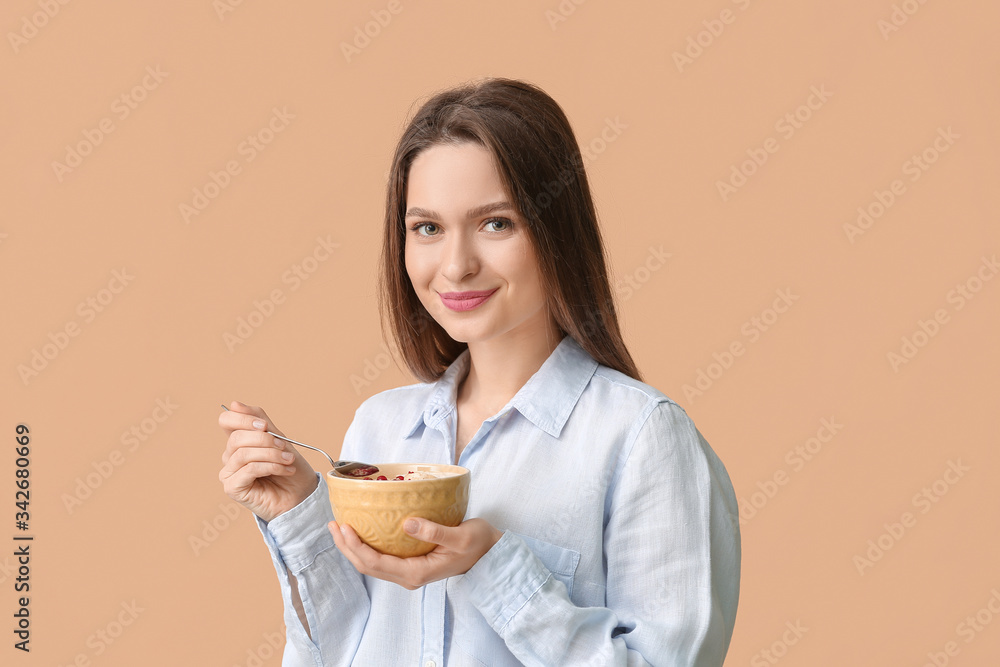 Young woman with tasty yogurt on color background Young woman with tasty yogurt on color background