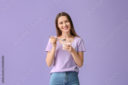 Young woman with tasty yogu...
