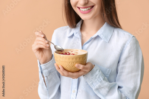Young woman with tasty yogu...