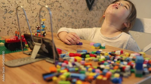 Covid-19 Coronavirus and Learning from home. Little girl online learning and creating at home. Quarantine and Social distancing concept.