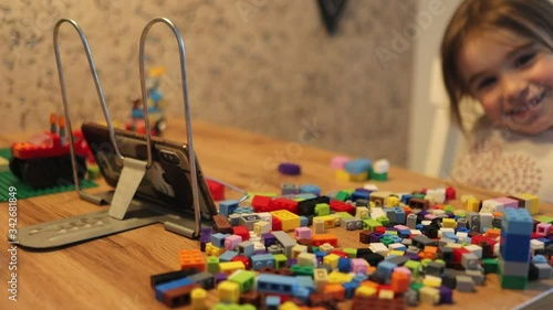 Covid-19 Coronavirus and Learning from home. Little girl online learning and creating at home. Quarantine and Social distancing concept.