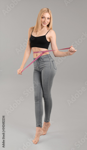 Slim woman with measuring t...