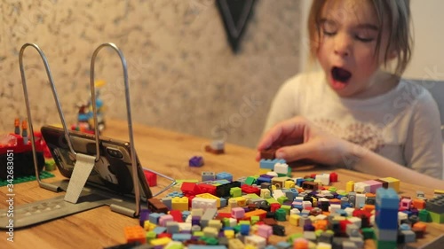 Covid-19 Coronavirus and Learning from home. Little girl online learning and creating at home. Quarantine and Social distancing concept.