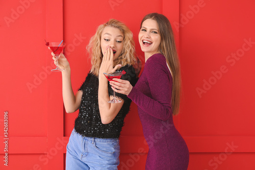 Happy women with cocktails ...