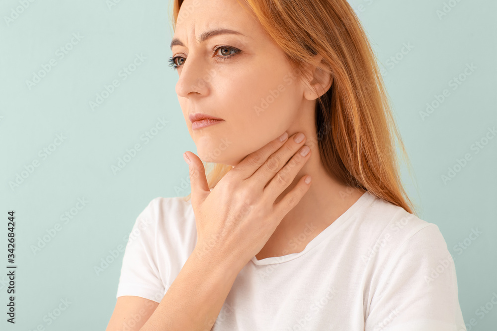 Woman with thyroid gland problem on light background Woman with thyroid gland problem on light background