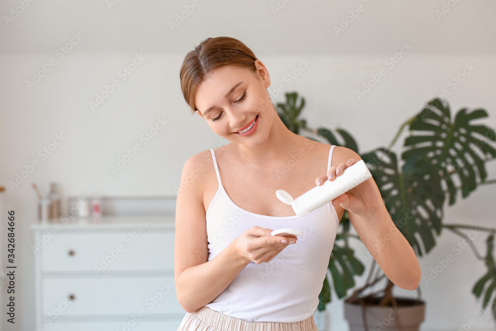 Beautiful young woman removing makeup at home Beautiful young woman removing makeup at home