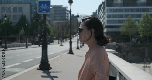 Woman walking on a bridge at Paris during the summer