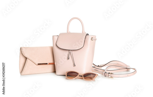Different stylish woman's bags and sunglasses isolated on white