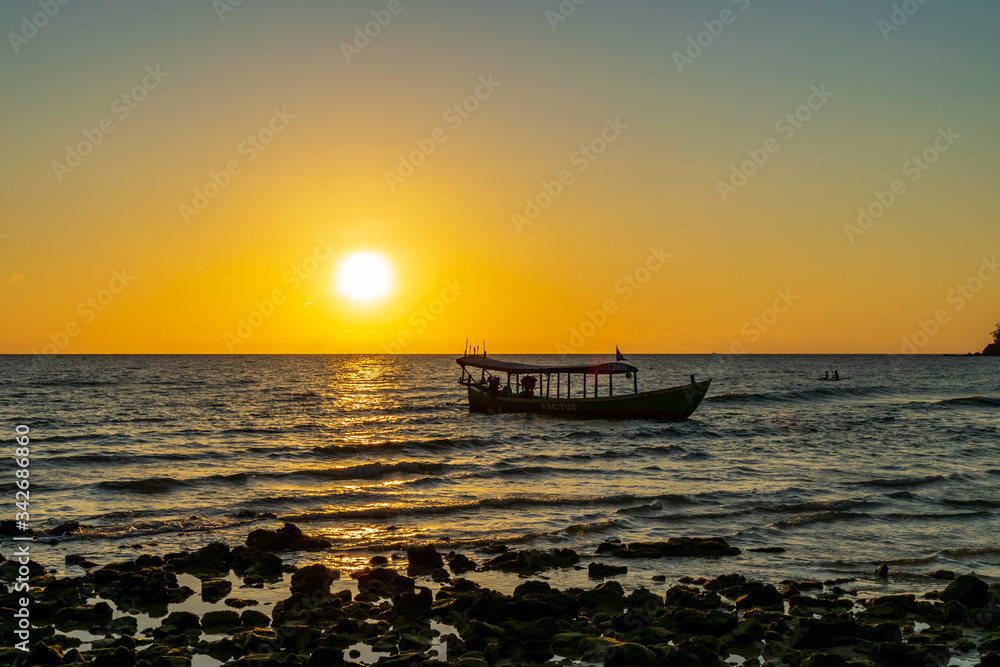 A boat in the sea with the sunset background at Koh Ta Kiev, Cambodia