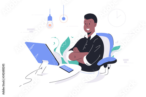 Happy african american businessman crossing hands using computer and smartphone.