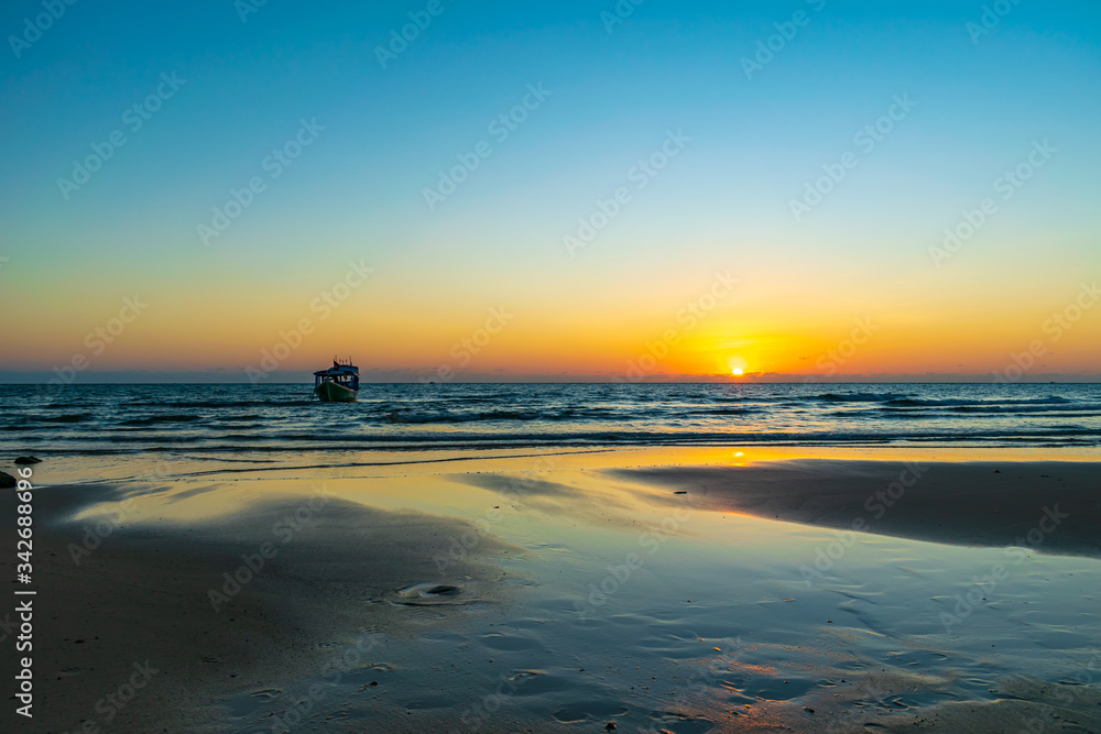 Koh Ta Kiev, Cambodia- Feb, 2020 : a boat in the sea with the sunset background at Koh Ta Kiev, Cambodia