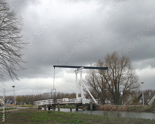 black and white wooden drawbridge over the ring canal of the Zuidplaspolder called 