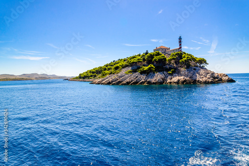 Croatian island with lighthouse on Vela Sestrica near Kornati, Adriatic Sea, Croatia, panoramic view. Vacation travel concept. photo