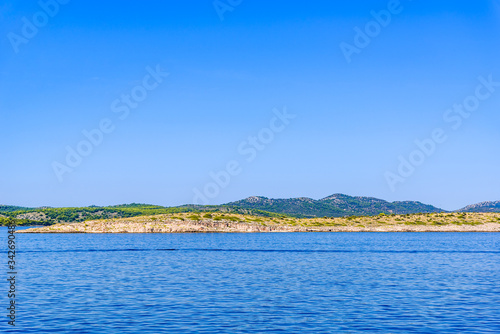 Landscape of Sea and Croatian coast, scenic view during the cruise in the Adriatic Sea with rocky beach in Croatia. Vacation and travel concept