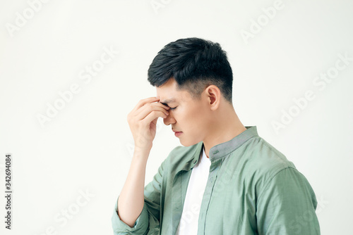 Depressed young business man holding his head