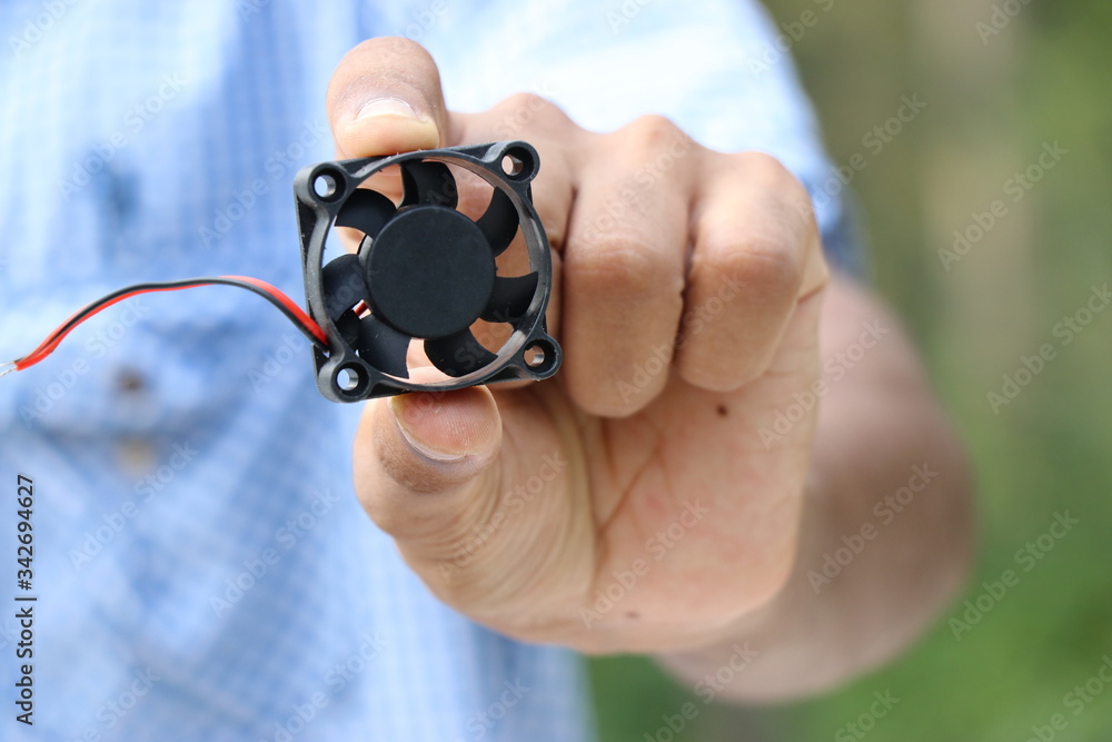 Fototapeta premium Mini CPU Cooler held in hand 