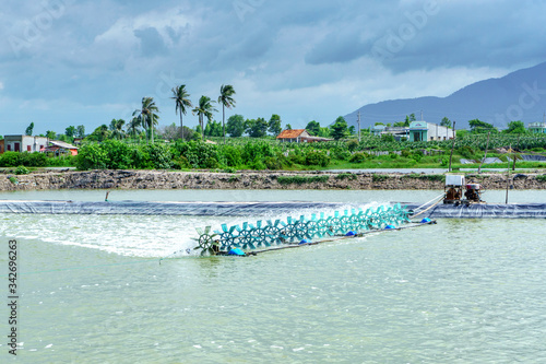 Billede på lærred Aerial view of the prawn farm with aerator pump in front of Ba Ria Vung Tau, Vietnam