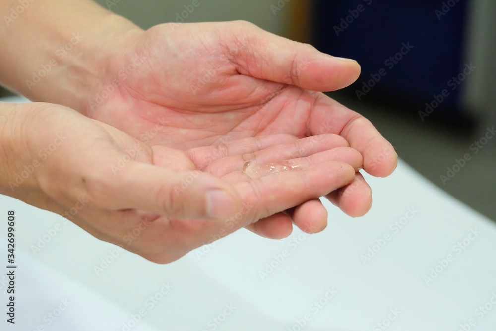 Fototapeta premium Close up a male hands with sanitizer alcohol gel for cleaning hands hygiene prevention of Corona virus outbreak 