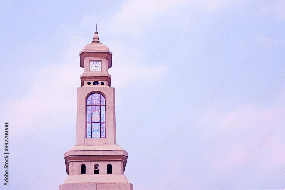 Clock Tower under cloudy sky background on the left of photo Clock Tower under cloudy sky background on the left of photo