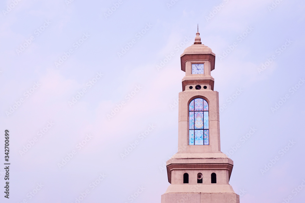 Clock Tower under cloudy blue sky background on the right of photo