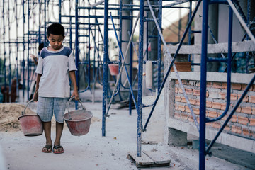 Children are forced to work in the construction area. Human rights concepts, stopping child abuse, violence, fear of child labor and human trafficking