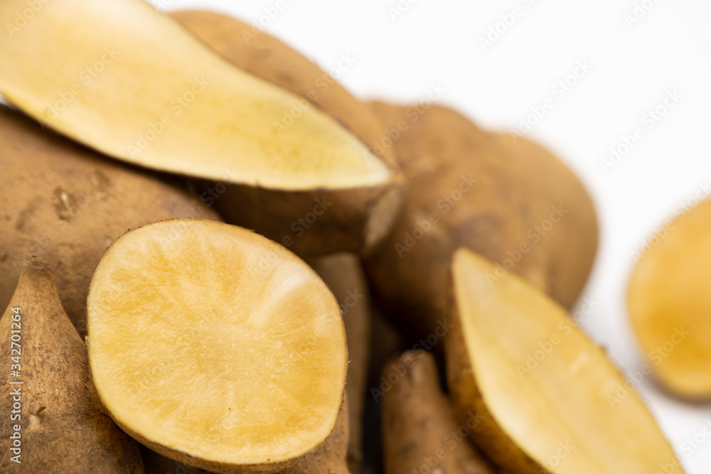 Pile of smallanthus sonchifolius or yacon or snow lotus with sliced isolated on white background Pile of smallanthus sonchifolius or yacon or snow lotus with sliced isolated on white background