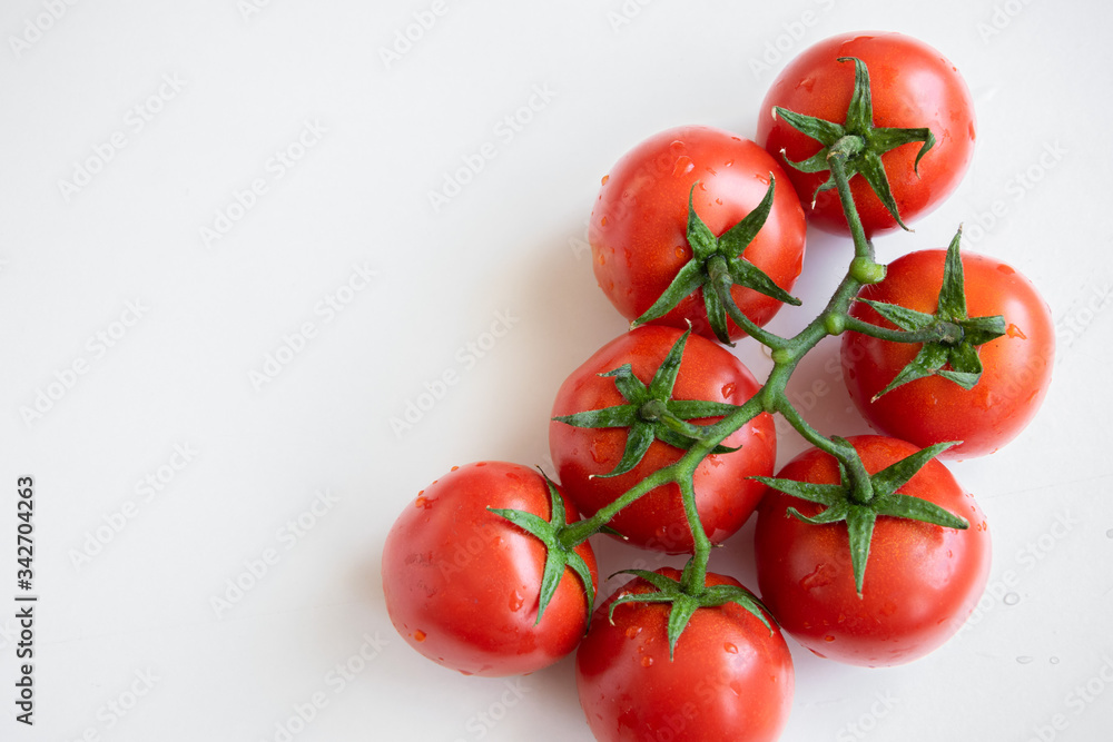 Healthy food ingredient - raw tomatoes on white background, vibrant colours, vitamin food, space for text Healthy food ingredient - raw tomatoes on white background, vibrant colours, vitamin food, space for text