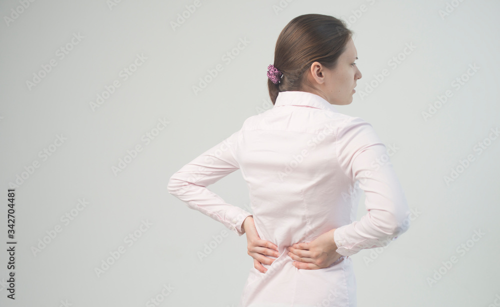 Tired woman feeling neck pain, massaging tense muscles. back pain and lower back view Tired woman feeling neck pain, massaging tense muscles. back pain and lower back view