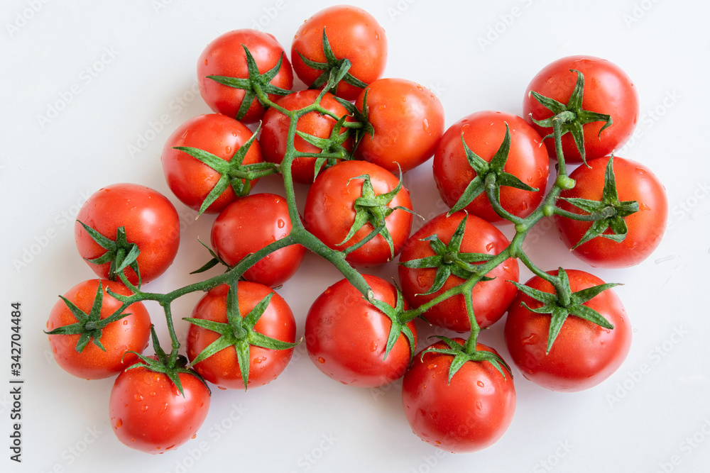 Healthy food ingredient - raw tomatoes on white background, vibrant colours, vitamin food, space for text Healthy food ingredient - raw tomatoes on white background, vibrant colours, vitamin food, space for text