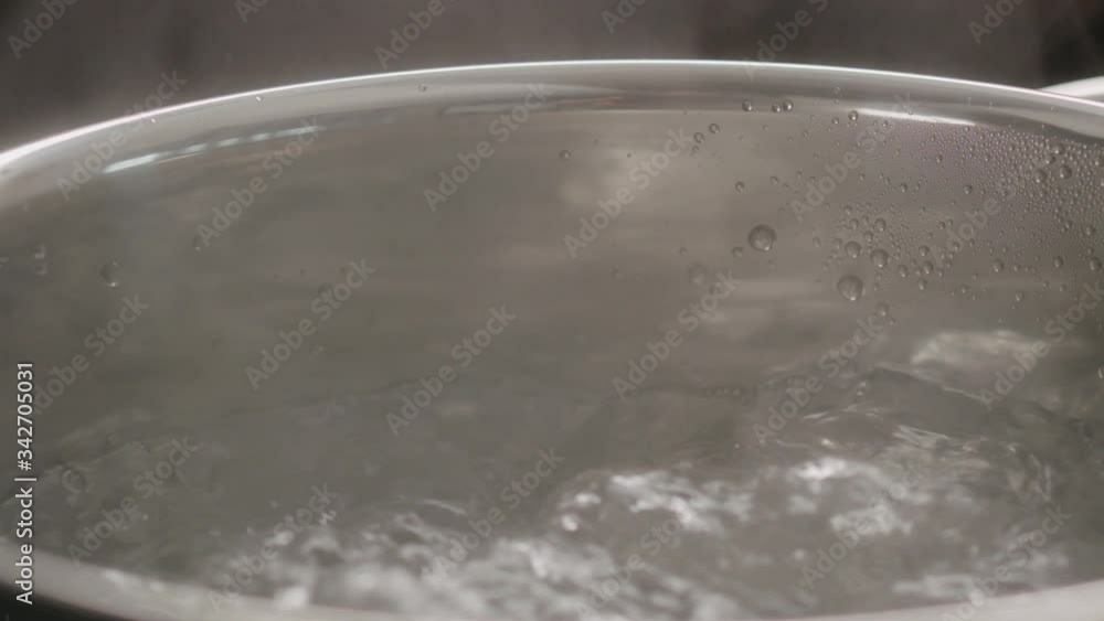 Slow motion handheld shot of boiling water in pot closeup Slow motion handheld shot of boiling water in pot closeup