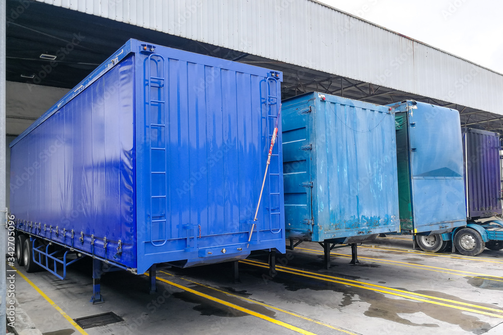 Container box docked at warehouse to load and unload goods for delivery