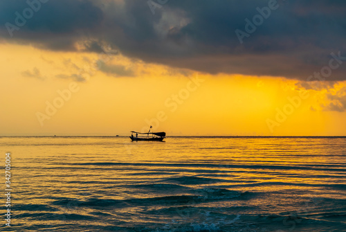 A boat in the sea with the sunset background at Koh Ta Kiev, Cambodia
