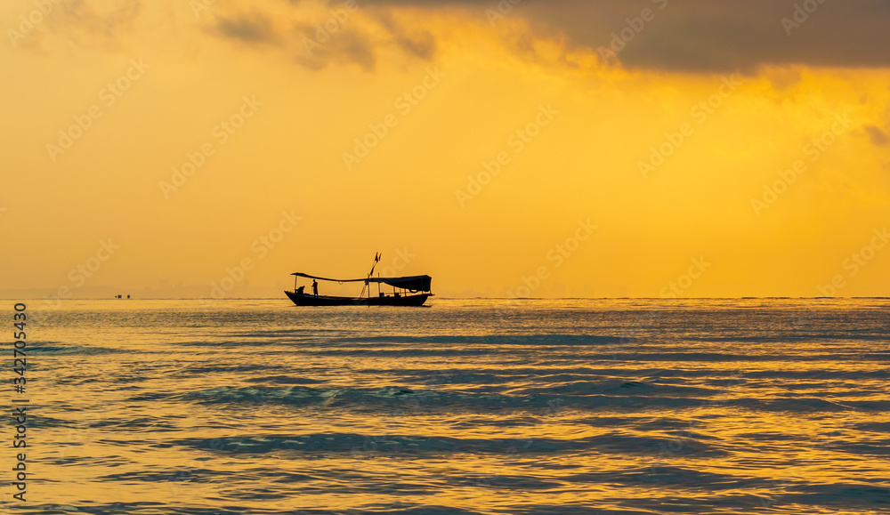 A boat in the sea with the sunset background at Koh Ta Kiev, Cambodia A boat in the sea with the sunset background at Koh Ta Kiev, Cambodia
