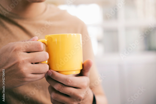 Close up man hands holding a cup of coffee