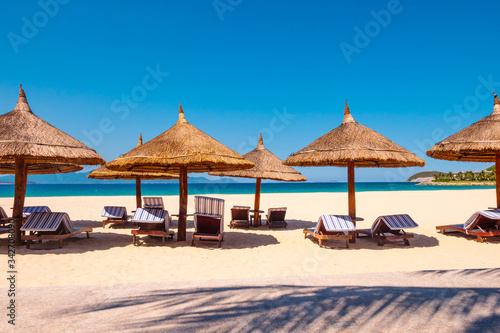 Luxury resort. Umbrellas and chairs on the beach near ocean