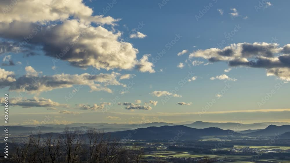 Zoom out time lapse clouds rolling over Slovenia landscape. Ljubljana basin with hills in distance Zoom out time lapse clouds rolling over Slovenia landscape. Ljubljana basin with hills in distance
