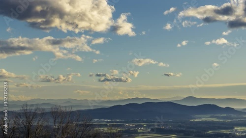 Wallpaper Mural Zoom out time lapse clouds rolling over Slovenia landscape. Ljubljana basin with hills in distance Torontodigital.ca