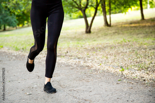 A young woman Jogging in the Park. Legs close up.