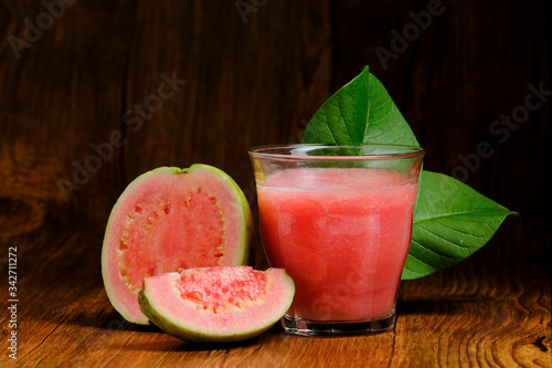 guava juice is served on a wooden background