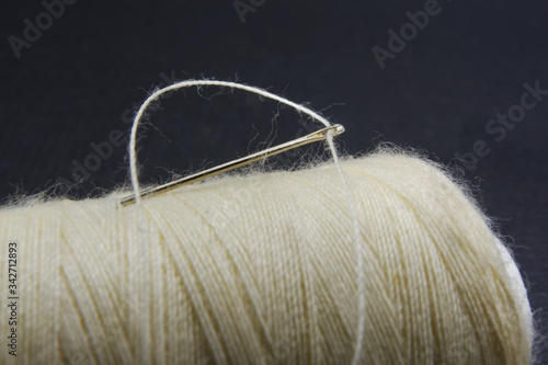 A thread through needle hole on a thread roll