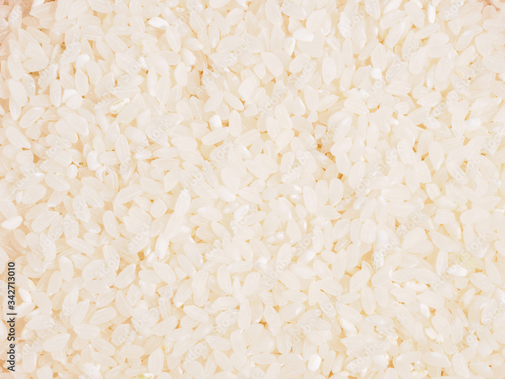 Raw white round grain rice as background. Healthy eating concept Raw white round grain rice as background. Healthy eating concept