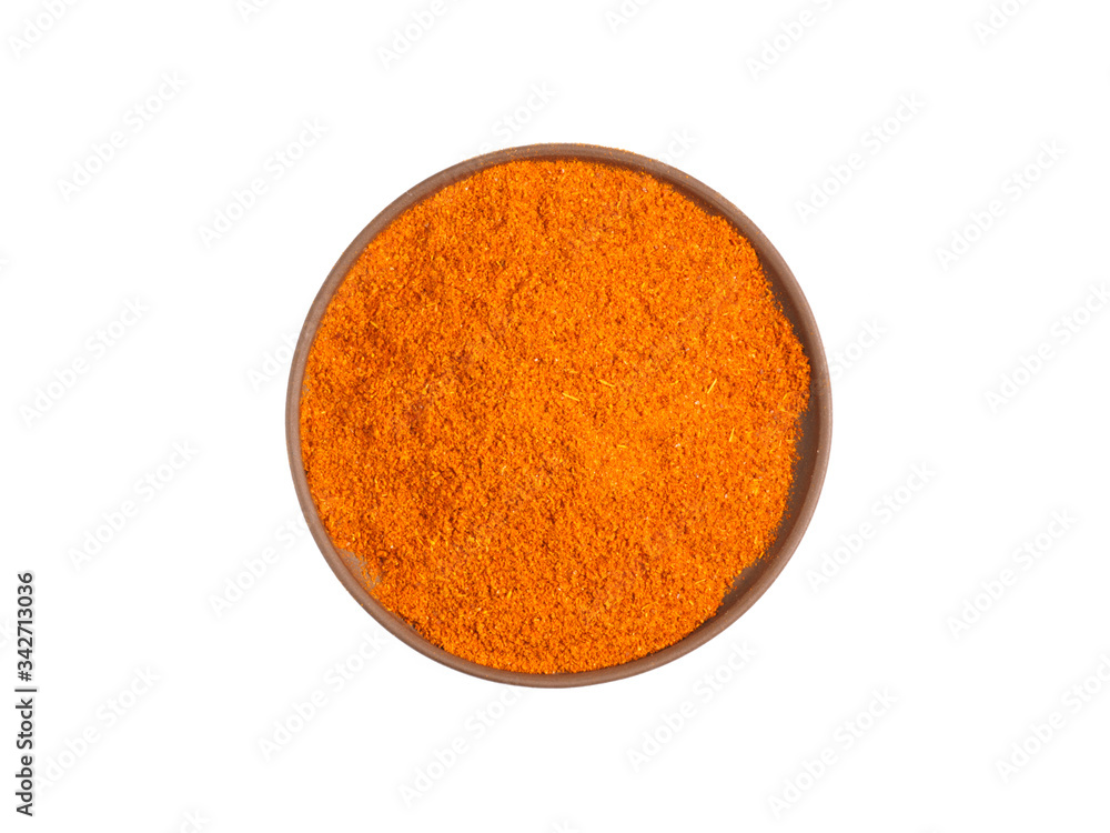 Red chili pepper powder on brown clay plate isolated on white Red chili pepper powder on brown clay plate isolated on white