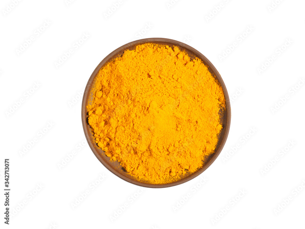 Turmeric (curcuma) powder on brown clay plate isolated on white Turmeric (curcuma) powder on brown clay plate isolated on white
