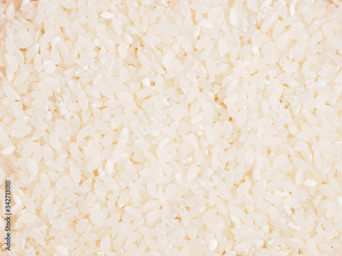 Raw white round grain rice as background. Healthy eating concept